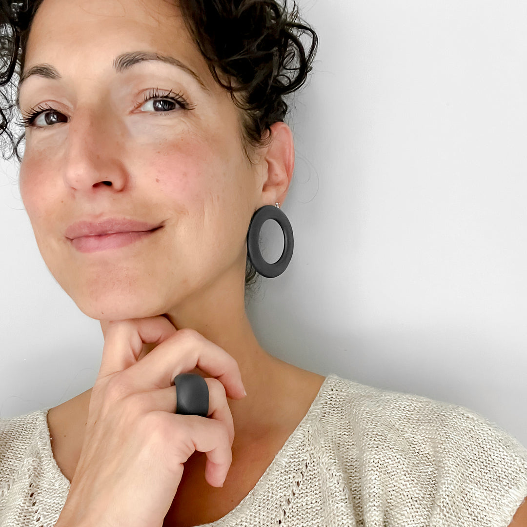 Carrie Norin wearing handmade black porcelain hoop earrings