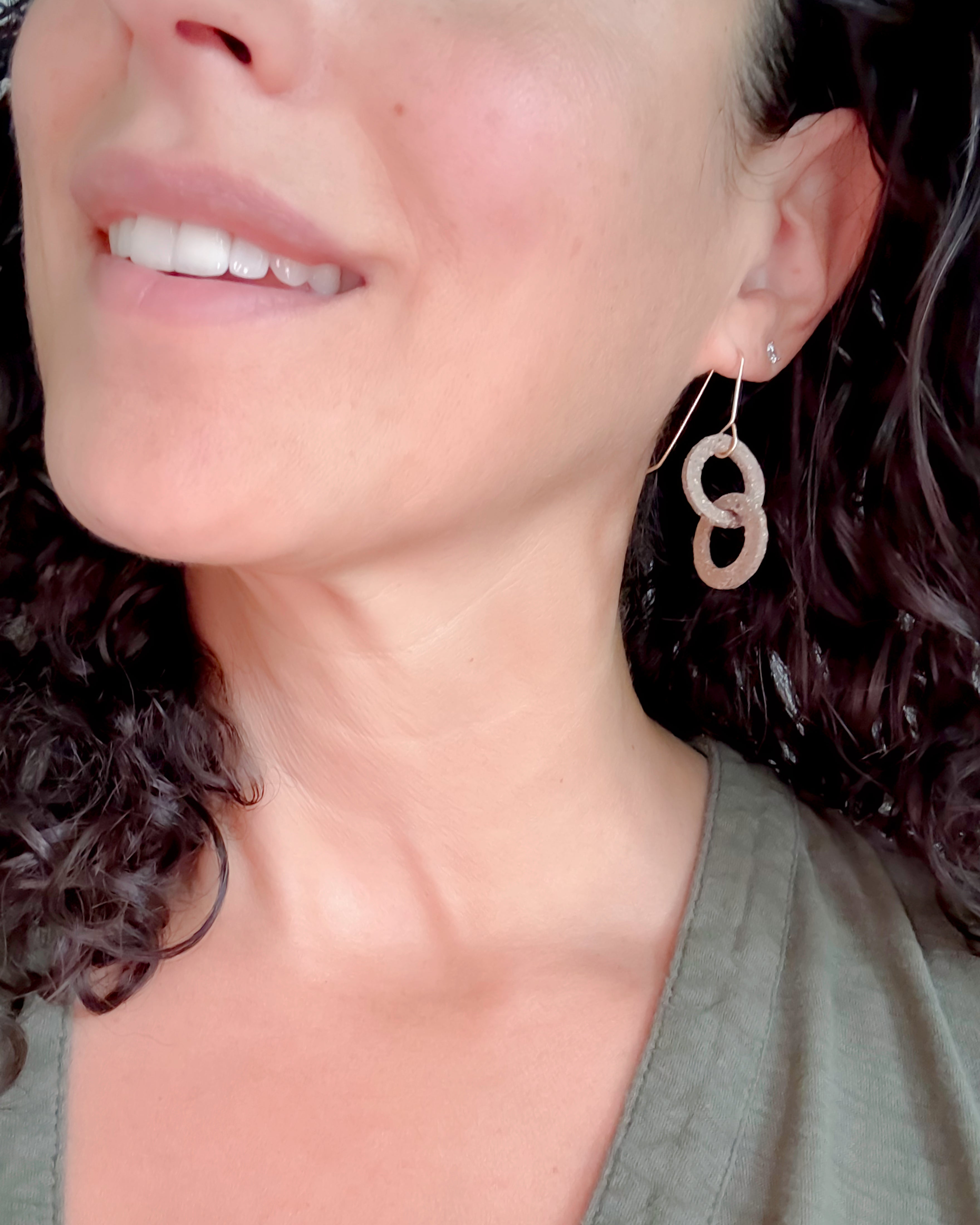 Close-up of a woman wearing a double circle earring.