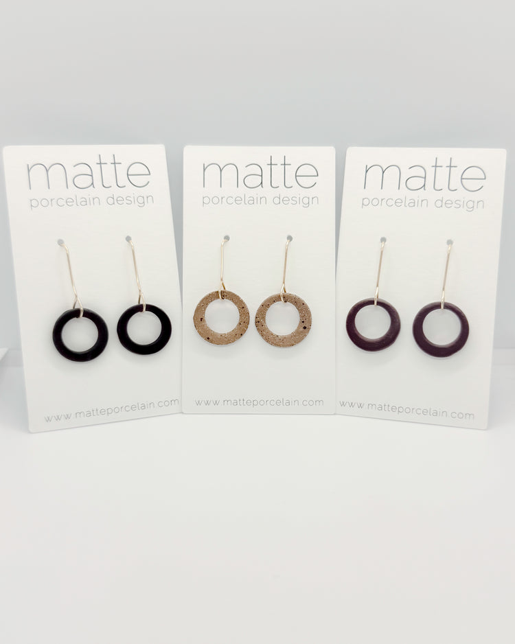Set of three pairs of earrings on cards with 'matte' branding.