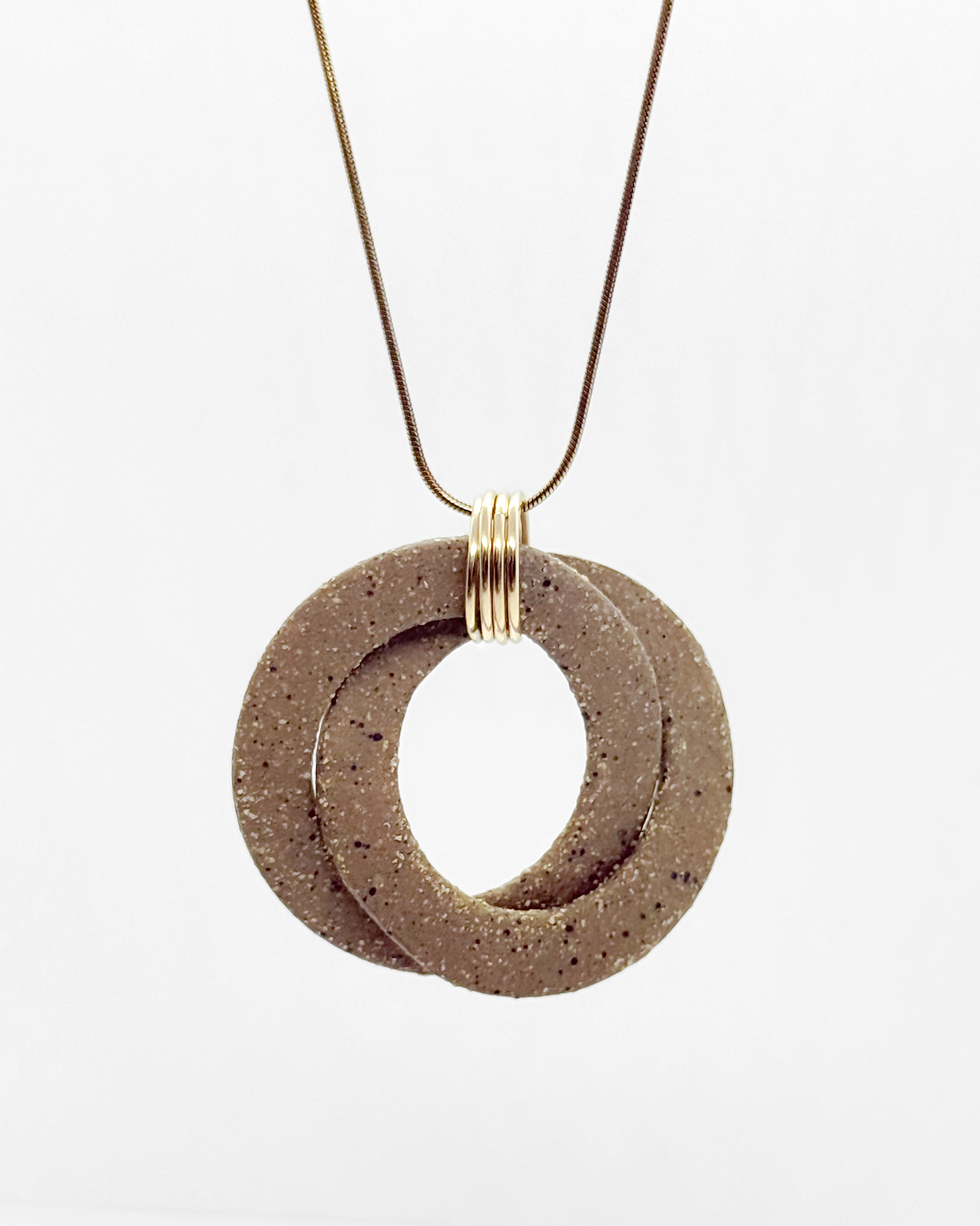 Necklace with two interlocking circular pendants on a white background