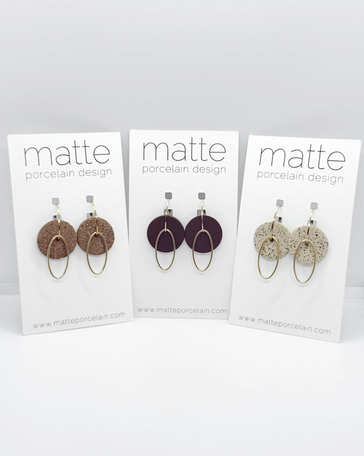 Three cards displaying earrings with 'matte porcelain design' branding on a white background.