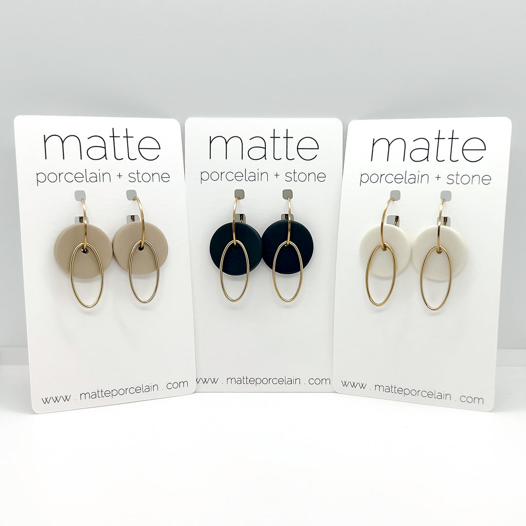 Three sets of earrings on 'matte porcelain + stone' display cards.