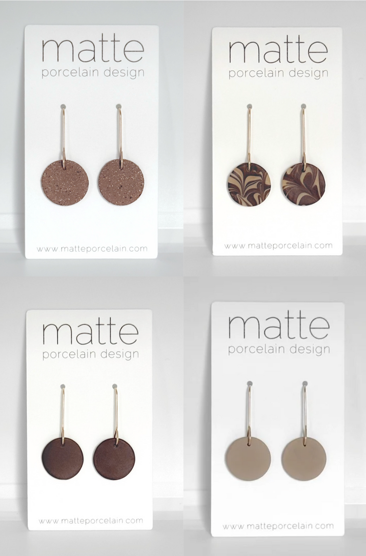 Four packages of Matte Porcelain Design products on a white background